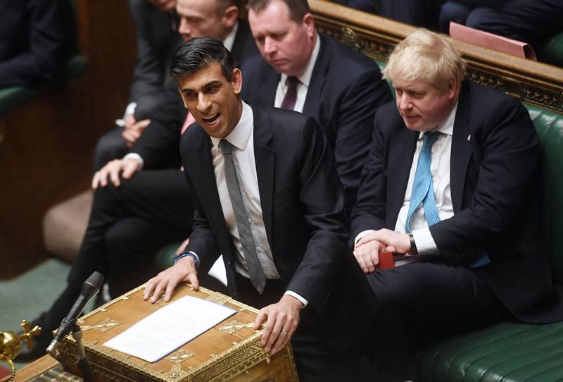 Britain's Prime Minister Boris Johnson looks on as Britain's Chancellor of the Exchequer Rishi Sunak presents the Spring Budget statement to MPs at the House of Commons, in London, on March 23. AFP