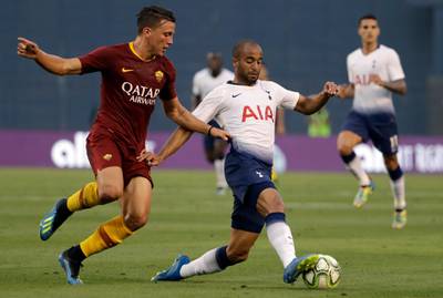 Tottenham's Lucas Moura holds off Roma's Luca Pellegrini. AP Photo