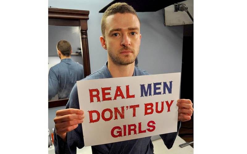 Justin Timberlake holds up a Real Men Don’t Buy Girls sign in support of the Nigerian schoolgirls. Courtesy Justin Timberlake
