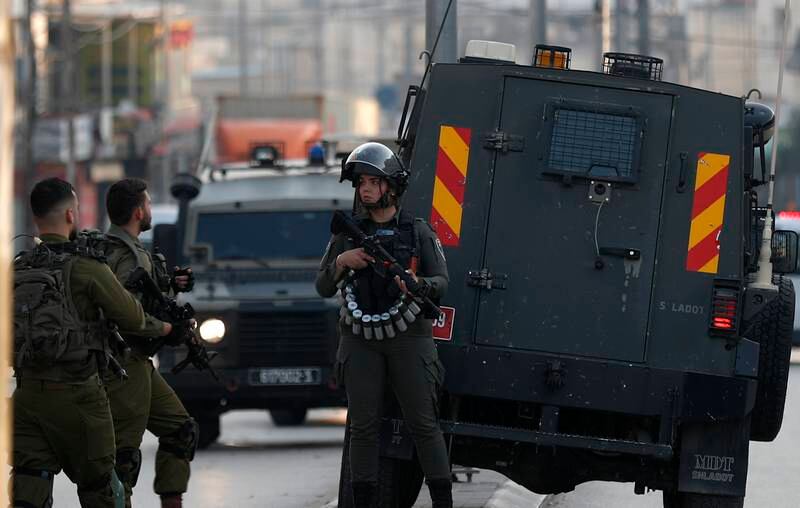 Israeli security forces block a road near the site of a shooting in the occupied West Bank town of Hawara on Sunday. EPA