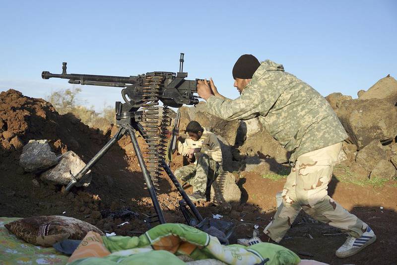 Rebel fighters of the southern front of the Free Syrian Army take positions as one of them aims his weapon at the front line in the north-west countryside of Deraa on March 3, 2015. Reuters
