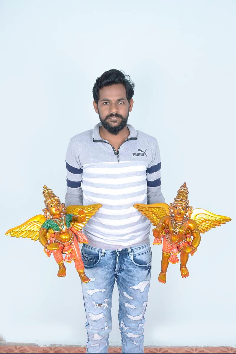Santoshkumar Chitragar with two of his handmade figurines