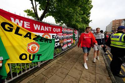 Fans walk to the ground ahead of an organised protest against the Manchester United owners. Getty