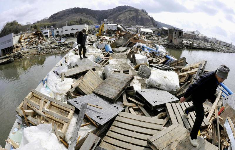 This combination photo shows a bridge taken March 22, 2011, top, and Friday, March 1, 2013, in Ishinomaki, Miyagi prefecture. Japan next week observes two years from the March 11, 2011 earthquake and tsunami which devastated the northeastern Pacific coast of the country. (AP Photo/Kyodo News) JAPAN OUT, MANDATORY CREDIT, NO LICENSING IN CHINA, FRANCE, HONG KONG, JAPAN AND SOUTH KOREA