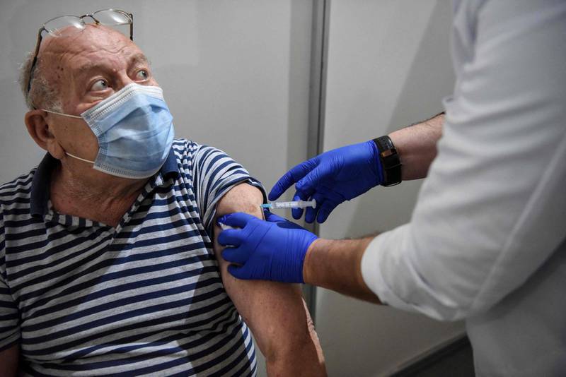 An elderly man receives a dose of the Sputnik V vaccine against the Covid-19 at the Boris Trajkovski sports hall in Skopje as the country start its vaccination campaign, after months of difficulties on April 16, 2021. Moscow announced on April 14, 2021 the start of production of its Sputnik V coronavirus vaccine in Serbia, the first European country outside Russia and Belarus to manufacture the vaccine. / AFP / Robert ATANASOVSKI
