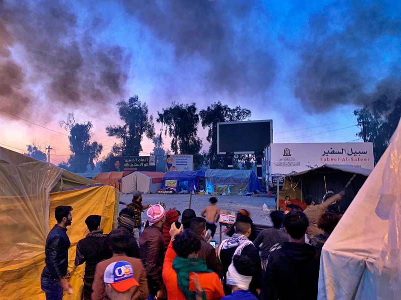 Smoke rises from the sites of anti-government protests in Najaf, Iraq, Wednesday, February 5, 2020. AP Photo/Anmar Khalil