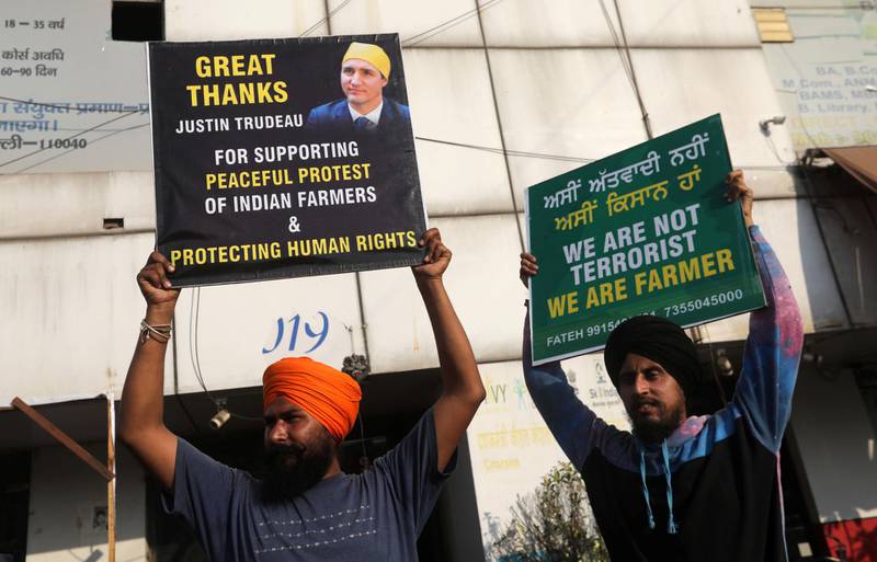 Farmers hold placards as they attend a protest during a nationwide strike against the newly passed farm bills at Singhu border near Delhi, India. Reuters