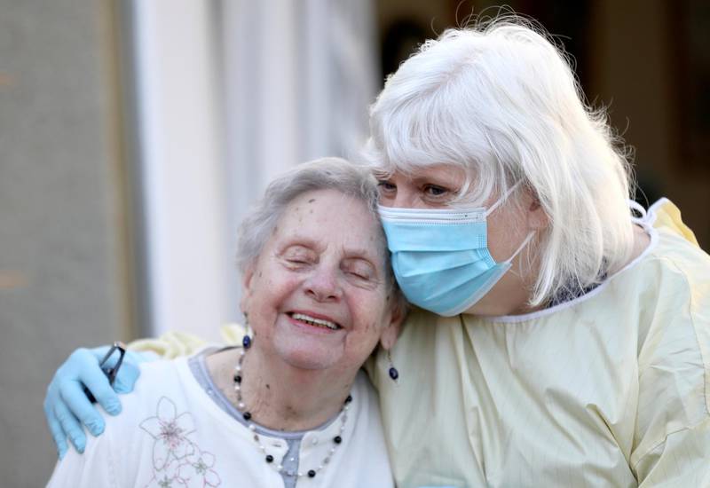 Fiona Scott visits her mother Mary Cook at a nursing home for the first time since the lockdown started in Scotland. Reuters