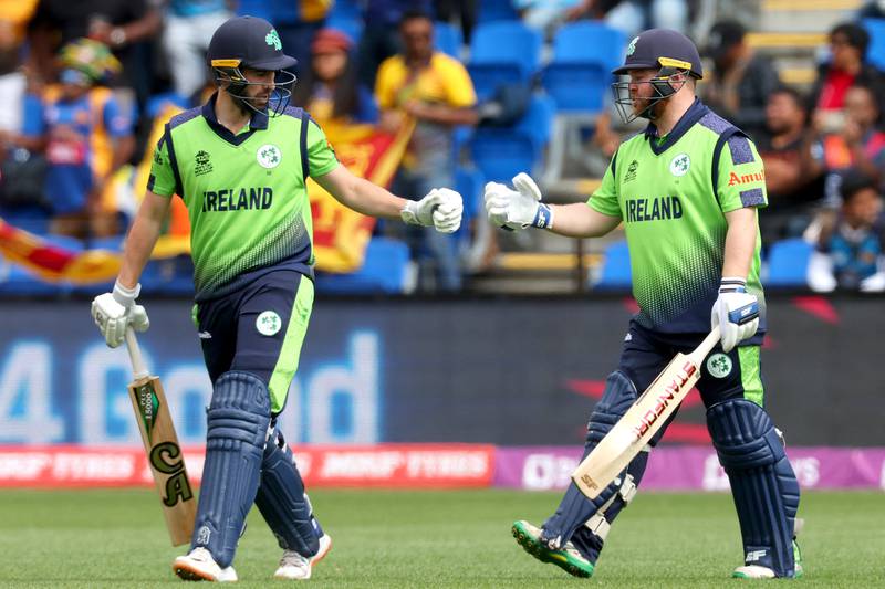Ireland captain Andrew Balbirnie and Paul Stirling bump gloves during the match. AFP