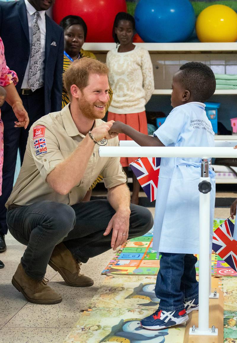 Prince Harry meets Barnaby Jose Mar, 6, as he visits the Princess Diana Orthopaedic Centre in Huambo, Angola. AP