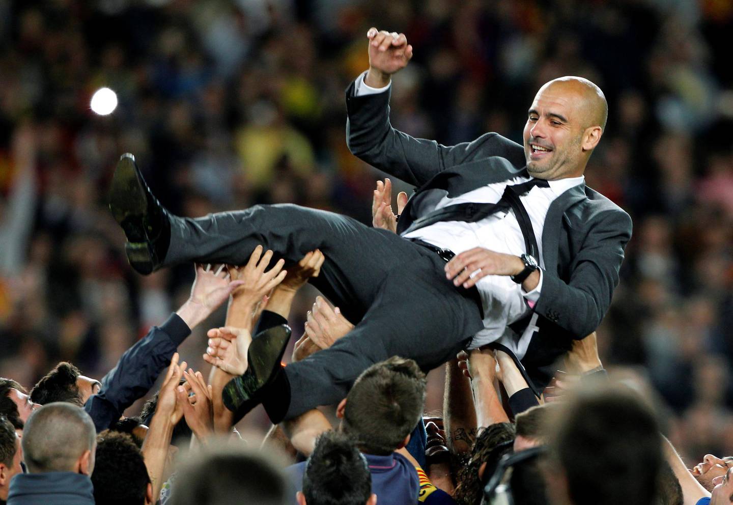 FILE PHOTO: ON THIS DAY -- May 5  May 5, 2012     SOCCER - Barcelona coach Pep Guardiola is tossed in the air by his players after his last game at the Camp Nou, a 4-0 victory over local rivals Espanyol in which striker Lionel Messi scored four times to take his tally for the season to 72 goals.     It was the perfect send-off for Guardiola, who won three La Liga titles, the Spanish Cup twice and Champions League twice in his four seasons managing the senior team.     "Life has given me this gift during the past five years of being able to live with these players and enjoy this spectacle," Guardiola told fans. "I have been the privileged one, to feel so loved and admired during all these years." REUTERS/Albert Gea/File photo