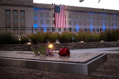 A rose lays on a bench at the National 9/11 Pentagon Memorial  in Arlington, Virginia.  The nation is marking the 20th anniversary of the terror attacks of September 11, 2001, when the terrorist group al-Qaeda flew hijacked airplanes into the World Trade Center, Shanksville, PA and the Pentagon, killing nearly 3,000 people.    AFP