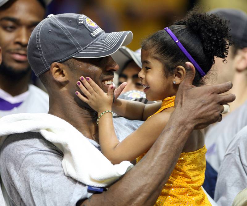 In this June 14, 2009, photo, Los Angles Lakers guard Kobe Bryant celebrates with his daughter Gianna, following the Lakers 99-86 defeat of the Orlando Magic in Game 5 of the NBA Finals at Amway Arena in Orlando. (Stephen M. Dowell/Orlando Sentinel via AP)