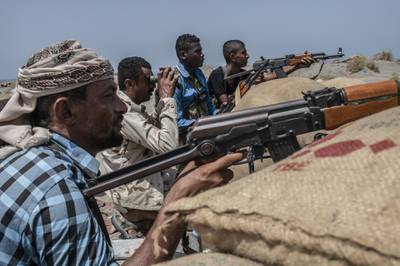 HODEIDAH, YEMEN - SEPTEMBER 21: Fighters from Hodeidah aligned with Yemen's Saudi-led coalition-backed government, looks for Houthi snipers at a frontline south of the city on September 21, 2018 in Hodeidah, Yemen. A coalition military campaign has moved west along Yemen's coast toward Hodeidah, where increasingly bloody battles have killed hundreds since June, putting the country's fragile food supply at risk. (Photo by Andrew Renneisen/Getty Images)