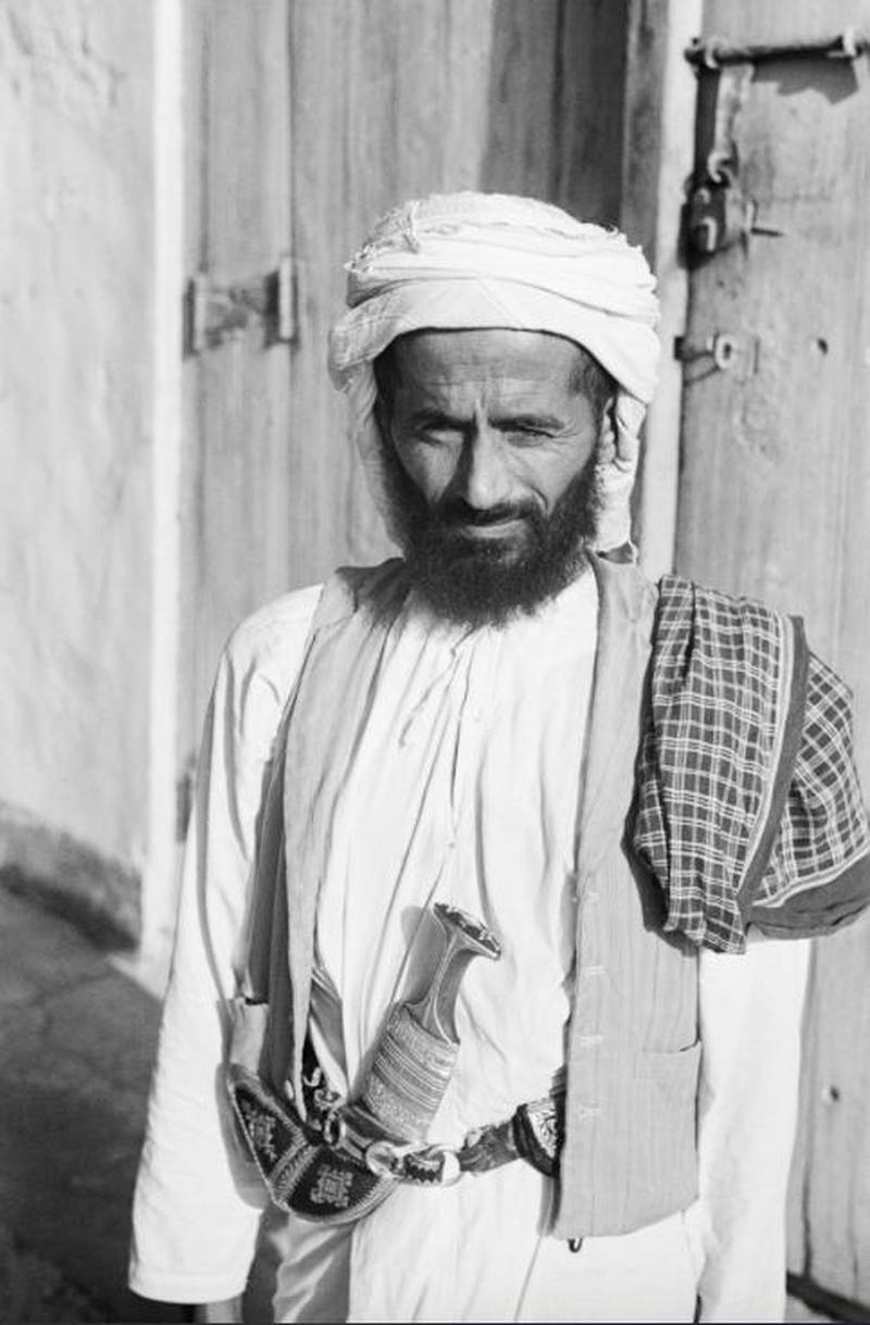 An Emirati man from the 1940s, wearing a vest on top of his kandura. His tarboosh is short and to the side. Photo via National Archives