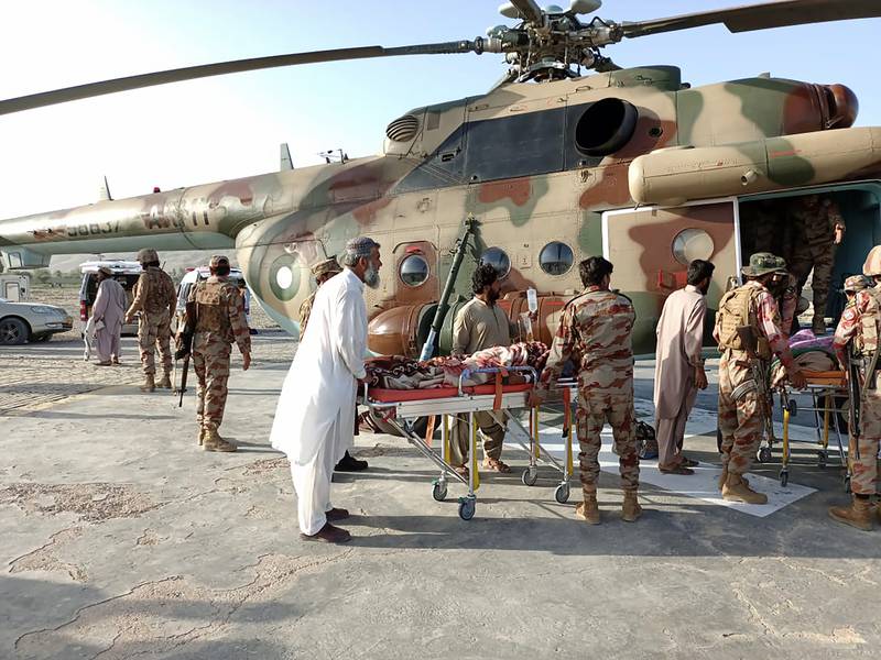 People injured in the earthquake are transferred in a Pakistan's army helicopter. AP Photo