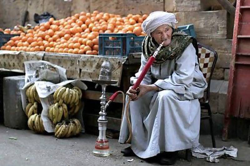 An Egyptian fruit vendor waits for customers in Cairo. Muhammed Muheisen / AP Photo
