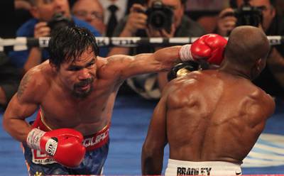 LAS VEGAS, NV - JUNE 09:  (L-R) Manny Pacquiao lands a left to the head of Timothy Bradley during their WBO welterweight title fight at MGM Grand Garden Arena on June 9, 2012 in Las Vegas, Nevada.  (Photo by Jeff Bottari/Getty Images)