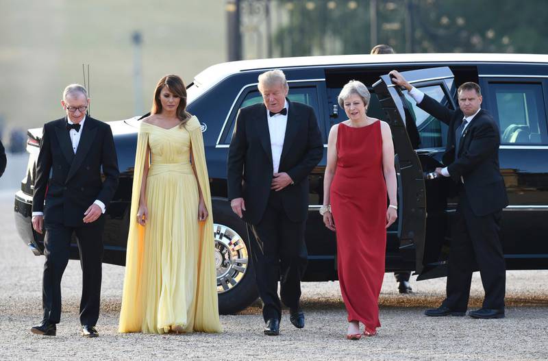 Theresa May, accompanied by her husband Philip, left, arrive with US President Donald Trump and his wife Melania for a black tie dinner at Blenheim Palace. AP