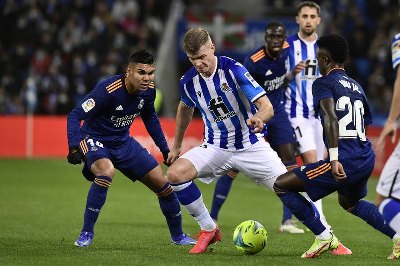 Real Sociedad's Alexander Sorloth, centre, challenges for the ball with Real Madrid's Casemiro. AP Photo