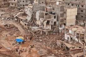 Rescuers and relatives of victims set up tents in front of collapsed buildings in Derna, Libya, on September 18.  AP