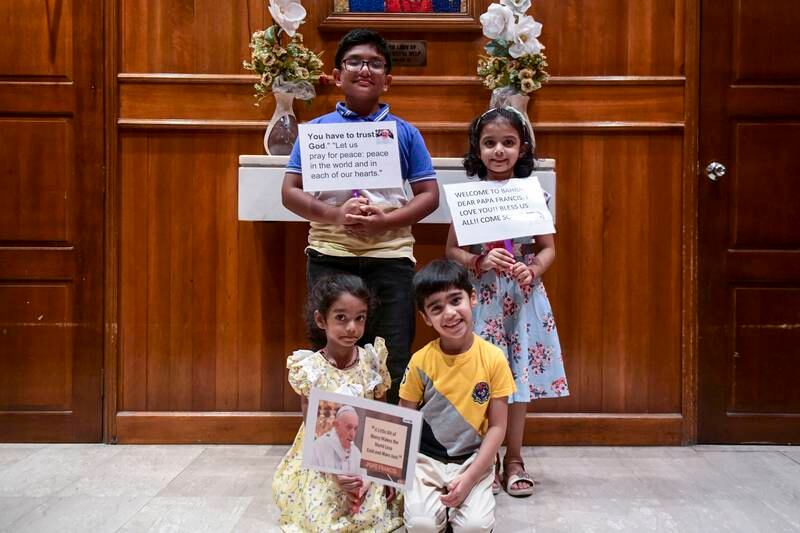 Clockwise, from left, Savion Pinto, 10, Honan Semona, 5, Jeff Fernandes, 5 and Evanka Sequeira, 4, with signs they made to welcome the pope to Manama.