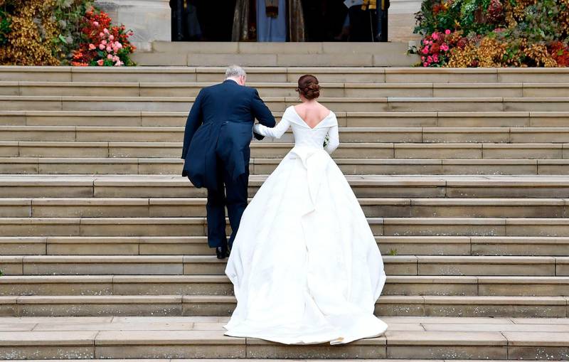 Britain's Princess Eugenie of York (R) arrives accompanied by her father Prince Andrew, Duke of York, (L) arrives to attend the wedding to Jack Brooksbank at St George's Chapel, Windsor Castle, in Windsor, on October 12, 2018. / AFP / POOL / TOBY MELVILLE
