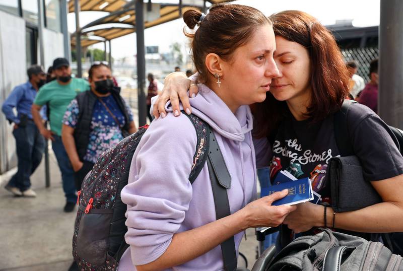 Ukrainian refugees Sasha Alexandra and Olena embrace shortly before being allowed to cross into the United States to seek asylum in Tijuana, Mexico.  They fled their city of Dnipro this month and travelled to Germany before flying to Mexico. AFP