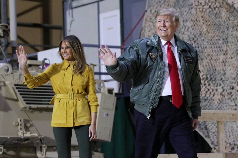 US President Donald Trump, with first lady Melania Trump, arrives to deliver remarks to US troops in an unannounced visit to Al Asad Air Base, Iraq. Reuters