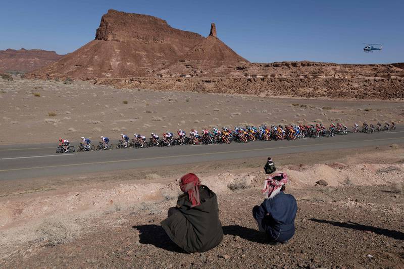 Locals watch as the peloton rides during the second stage of the Saudi Tour