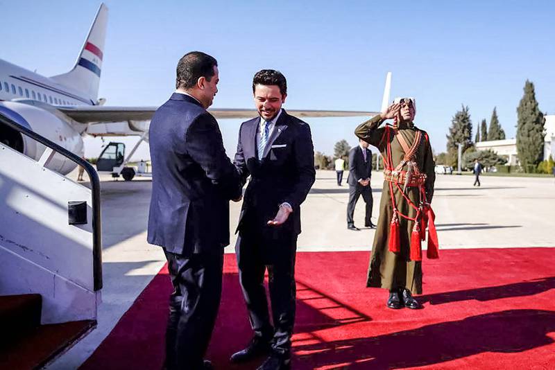 Prince Hussein welcomes Mr Shia Al Sudani. AFP