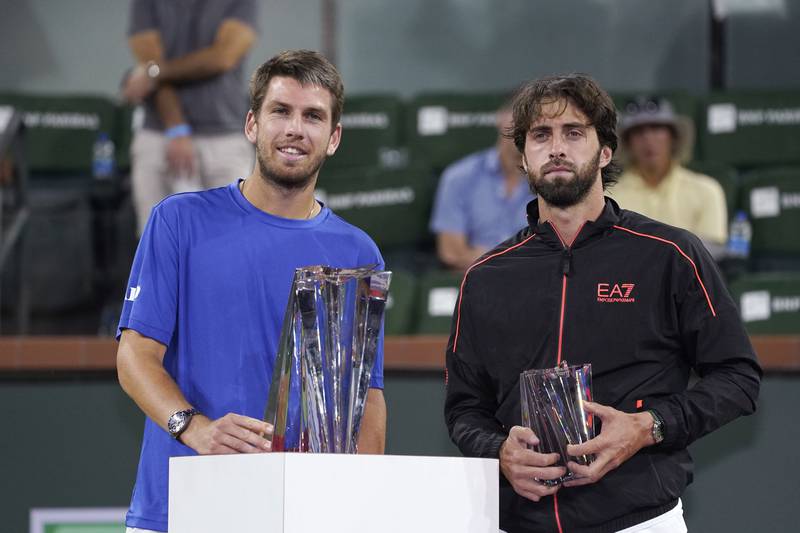 Cameron Norrie, left, of Britain, and Nikoloz Basilashvili, of Georgia, stand with their trophies after Norrie defeated Basilashvili in the singles final at the BNP Paribas Open tennis tournament Sunday, October 17, 2021, in Indian Wells. AP Photo