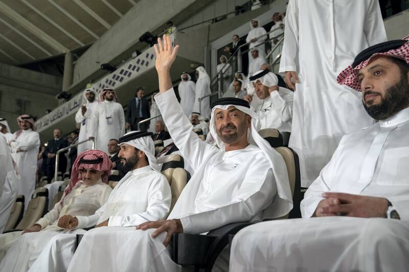 AL AIN, UNITED ARAB EMIRATES - April 18, 2019: HH Sheikh Mohamed bin Zayed Al Nahyan Crown Prince of Abu Dhabi Deputy Supreme Commander of the UAE Armed Forces (2nd R) attends the 2018–19 Zayed Champions Cup final football match between Al Hilal and Etoile du Sahel, at Hazza bin Zayed Stadium. Seen with HE Turki bin Abdul Mohsen Al Sheikh, Chairman of the General Entertainment Authority of Saudi Arabia (R), HH Sheikh Nasser bin Hamad bin Isa Al Khalifa, Representative of His Majesty the King for Charity Works and Youth Affairs and Chairman of the Board of Trustees of the Royal Charity Organisation of Bahrain (3rd R) and HRH Prince Alwaleed bin Talal bin Abdulaziz Al Saud (4th R).

( Mohamed Al Hammadi / Ministry of Presidential Affairs )
---