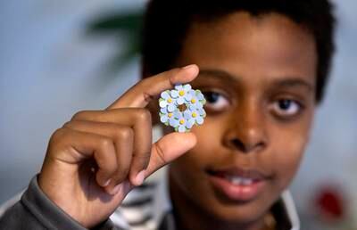Murhaf Hamid poses with a Mayflower pin he is selling for a children's charity in Glimakra, Sweden. EPA