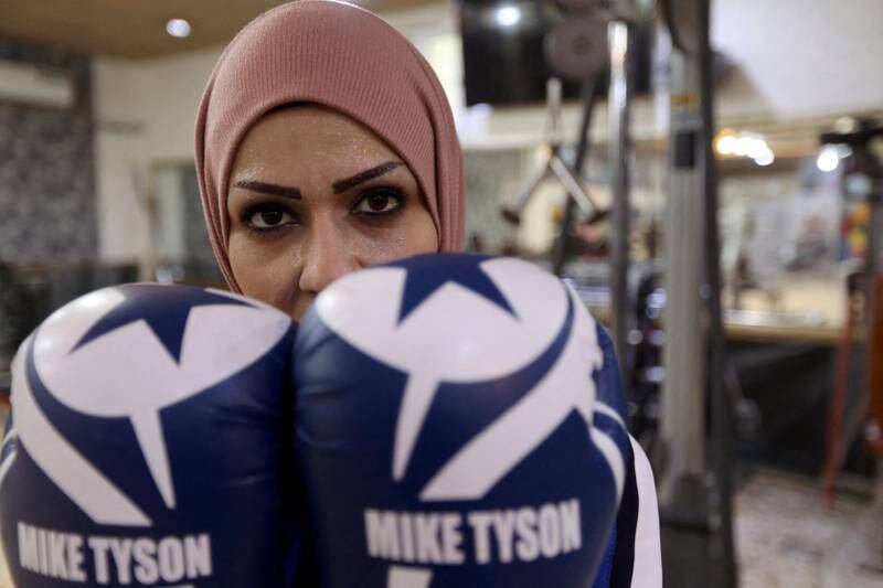 Bushra Abdul Zahra, a 36-year-old Iraqi local boxing and karate practitioner, poses for the camera at a gym in Najaf, Iraq December 24, 2021.  Picture taken December 24, 2021. REUTERS / Alaa Al-Marjani     TPX IMAGES OF THE DAY
