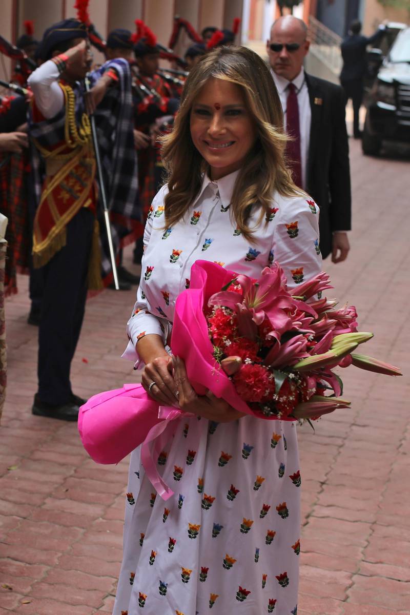U.S. First Lady Melania Trump hold a bouquet of flowers presented by children upon her arrival at Sarvodaya Co-Educational Senior Secondary School in New Delhi, India.  AP