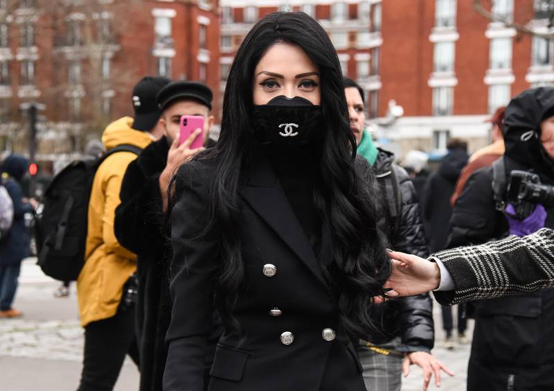 PARIS, FRANCE - FEBRUARY 28: A guest is seen wearing a Chanel mask outside the Balmain show during Paris Fashion Week: AW20 on February 28, 2020 in Paris, France. (Photo by Daniel Zuchnik/Getty Images)