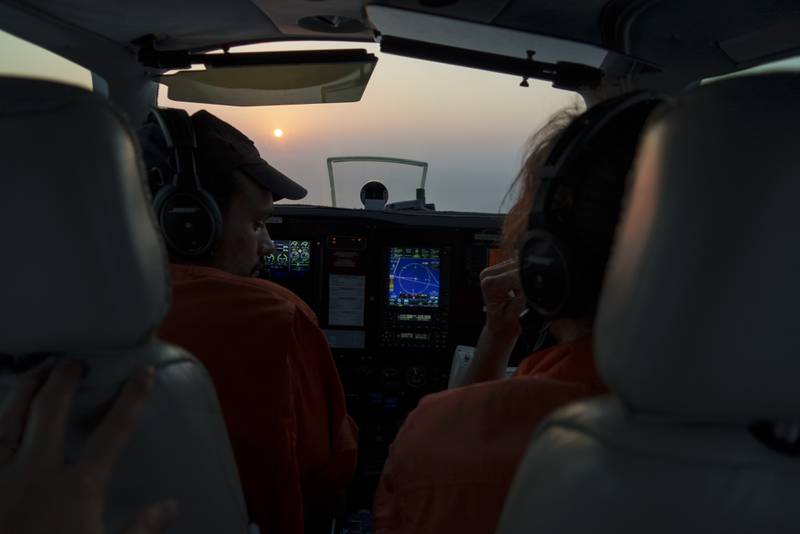 French volunteer pilot Augustin Clot, left, and tactical co-ordinator Jakob Fruehmann of Austria sit in the cockpit of 'Seabird', owned and operated by the German NGO Sea-Watch.