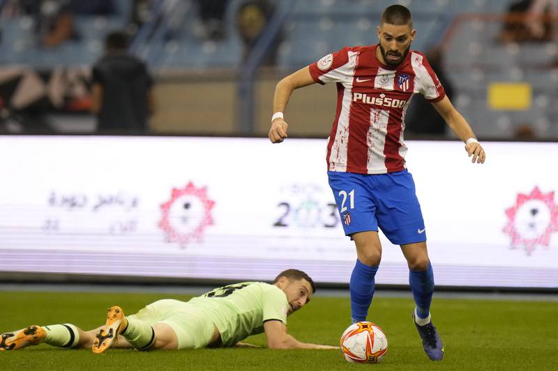 Atletico Madrid's Yannick Carrasco on the ball as Athletic Bilbao's Oscar de Marcos watches on from the ground. AP