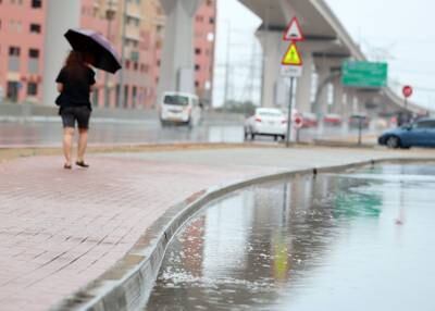Puddles and umbrellas in Discovery Gardens in Dubai, after a 45-minute deluge on Friday morning