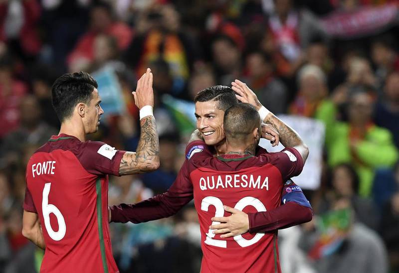 Cristiano Ronaldo celebrates with teammates after scoring against Latvia in World Cup 2018 qualifying on November 13, 2016. Francisco Leong / AFP