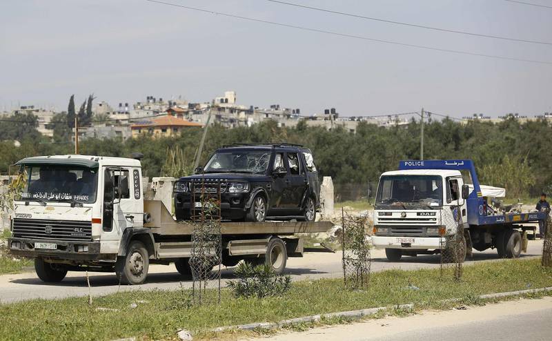 One of the cars of the Palestinian Prime Minister's convoy that was hit by an explosion being towed away to the Gaza strip Erez crossing, in Beit Hanun, the northern access point into the coastal Palestinian territory. Mohammed Abed / AFP