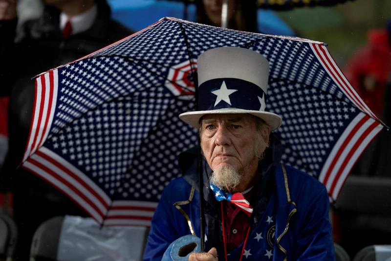 A voter waits for former US President Donald Trump to speak during a rally to boost Dr Mehmet Oz, ahead of the May 17 primary election in Greensburg, Pennsylvania. Reuters