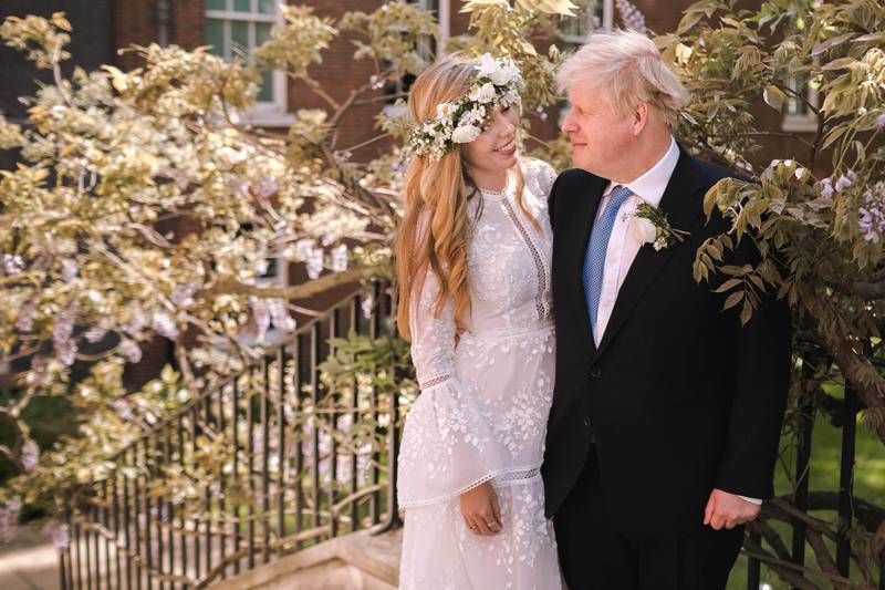 Mr Johnson poses with his wife Carrie in the garden of No 10, Downing Street following their wedding at Westminster Cathedral, in May 2021. Getty Images