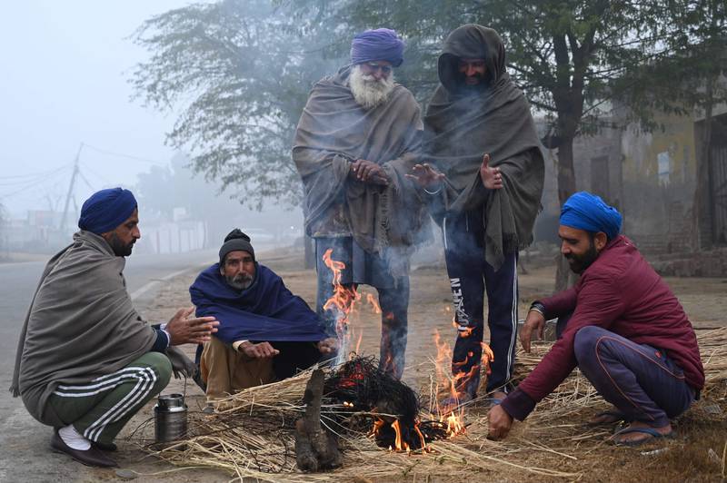 Villagers keep warm on a winter's day on the outskirts of Amritsar, India. AFP