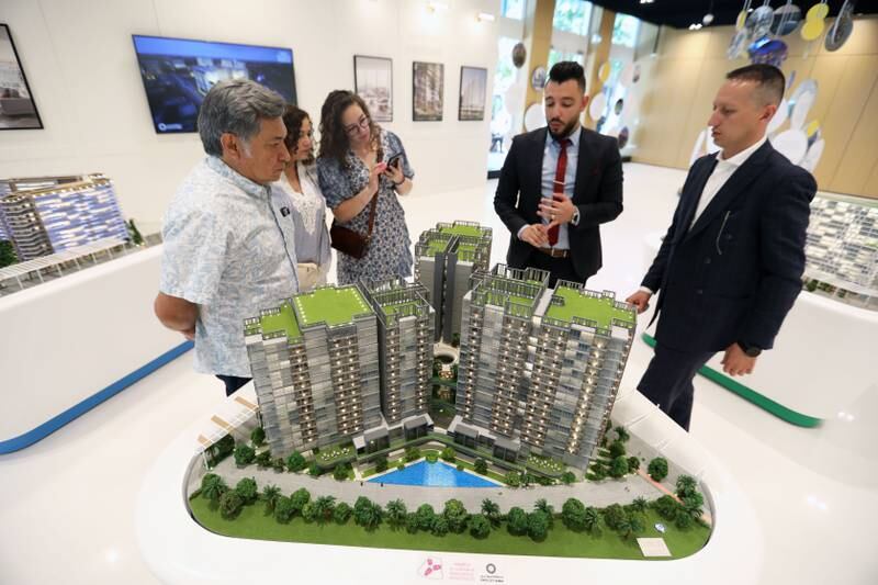 Sales agents show prospective buyers the apartments on sale at Expo City. Ruel Pableo / The National
