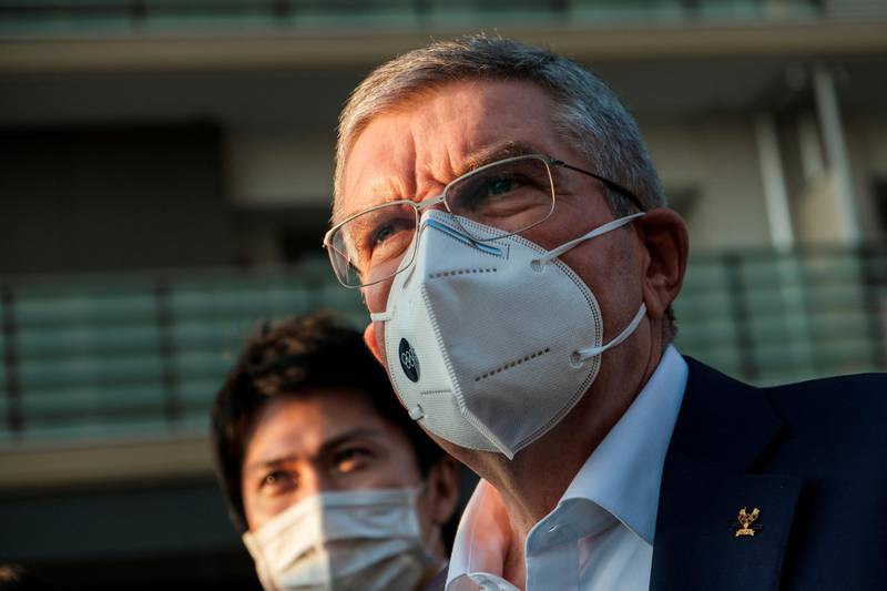 Thomas Bach, International Olympic Committee (IOC) president wearing a protective mask, talks to journalists during a visit to Olympic and Paralympic village in Tokyo, Japan. Reuters