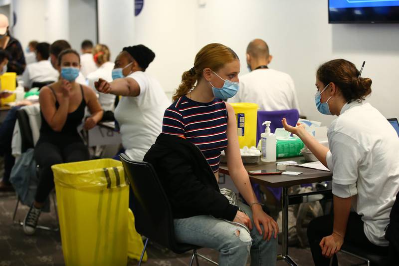 LONDON, ENGLAND - JUNE 19: A woman receives a vaccine at the Chelsea F.C. pop up vaccine hub on June 19, 2021 in London, England. Chelsea F.C. is offering Covid-19 jabs to all eligible locals over the age of 18. (Photo by Hollie Adams/Getty Images)