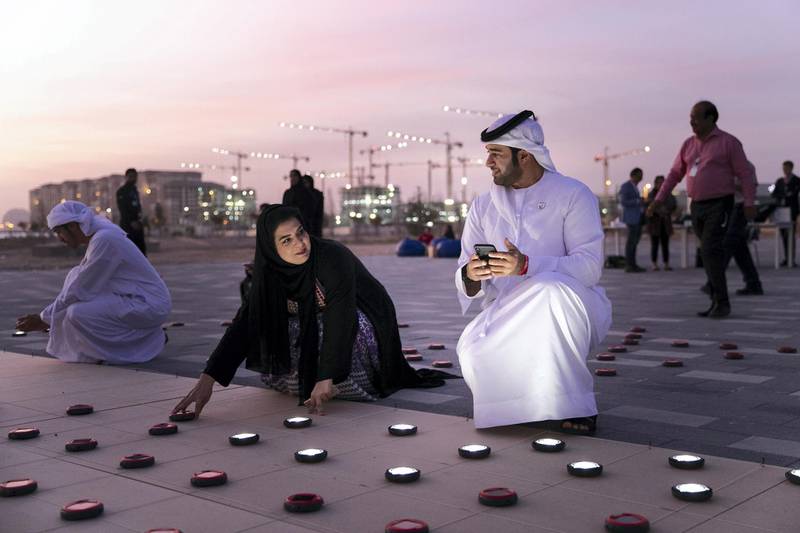 ABU DHABI, UNITED ARAB EMIRATES - JANUARY 9, 2019. Volunteers set up a 20mx20m light installation, comprised of 2,000 solar lanterns, arranged to reveal the Zayed Sustainability Prize logo.Following a month-long, five-country, transcontinental journey, the Zayed Sustainability Prizes Guiding Light campaign arrived to Abu Dhabi today. (Photo by Reem Mohammed/The National)Reporter: Section:  NA