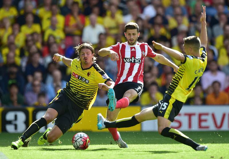 Watford's Sebastian Prodl, left, tackles Southampton's Shane Long during their Premier League contest on Sunday. Leon Neal / AFP